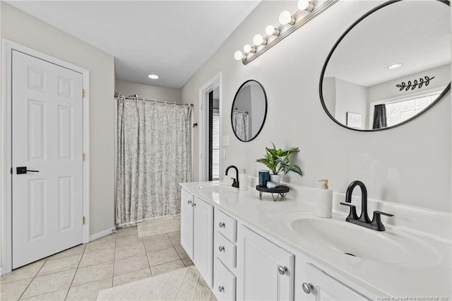 bathroom featuring tile patterned flooring and vanity