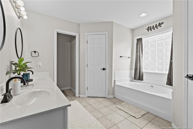 bathroom with vanity, tile patterned floors, and a bathing tub