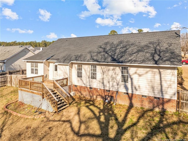 back of house with a deck and a yard