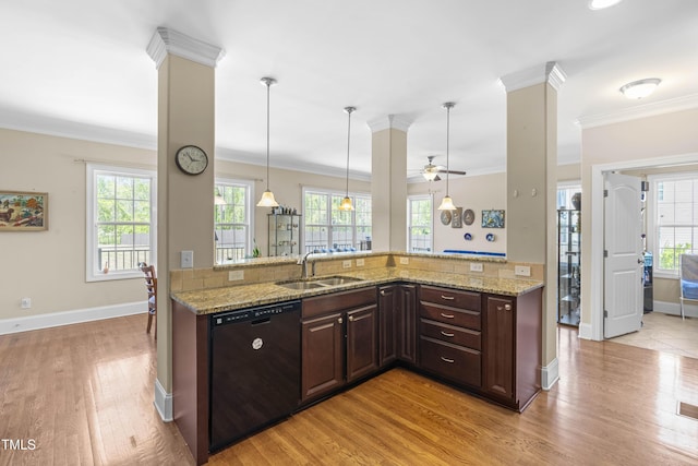 kitchen featuring black dishwasher, sink, hanging light fixtures, ornamental molding, and light stone counters