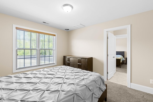 bedroom with light colored carpet