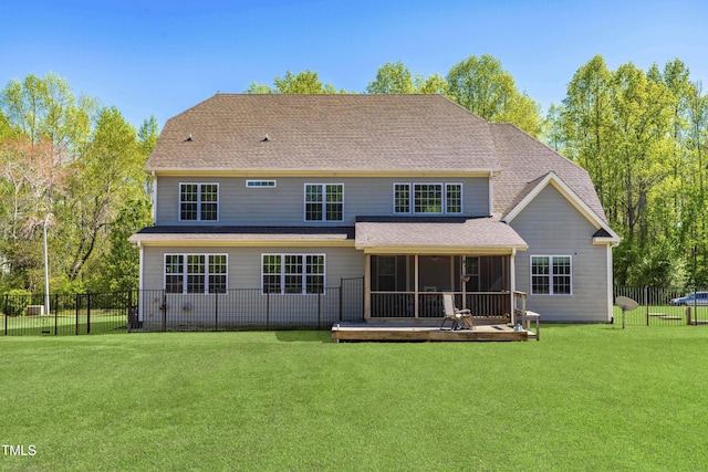 back of house featuring a yard, a deck, and a sunroom