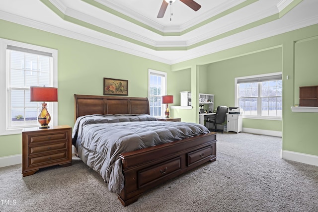 bedroom featuring a raised ceiling, crown molding, carpet flooring, and ceiling fan