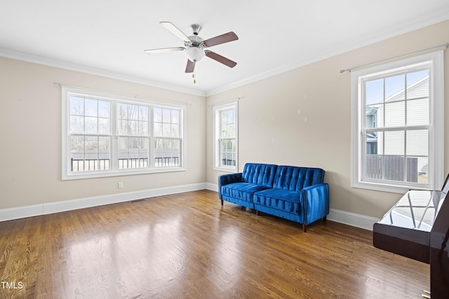 living area featuring ceiling fan, ornamental molding, and hardwood / wood-style floors