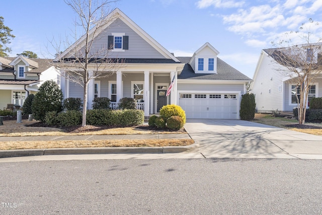 view of front of home with covered porch and a garage