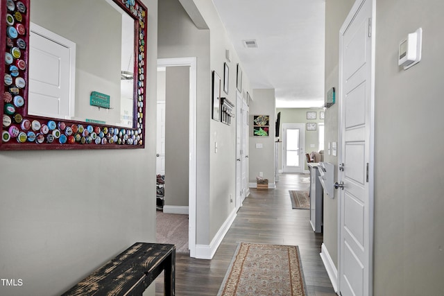 corridor with dark hardwood / wood-style flooring