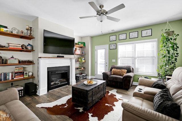 living room with ceiling fan and dark hardwood / wood-style flooring