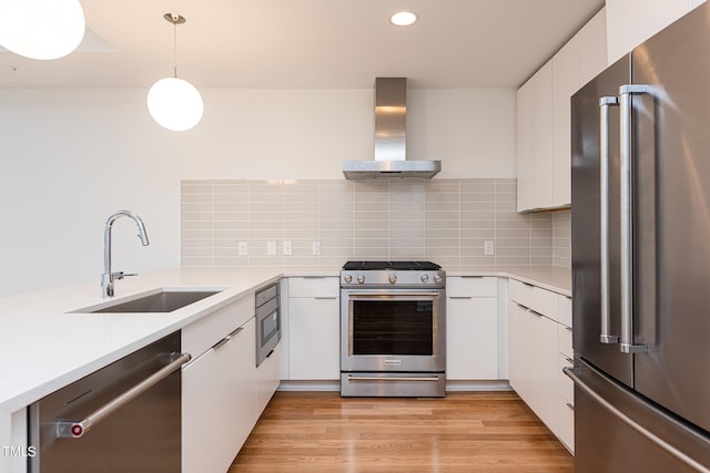 kitchen featuring stainless steel appliances, ventilation hood, and white cabinets