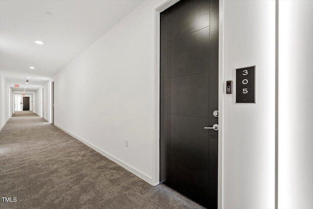 hall featuring carpet floors, baseboards, and recessed lighting