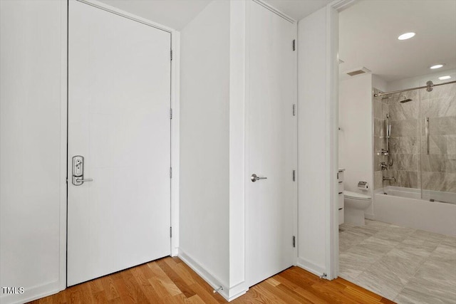 bathroom with recessed lighting, bathtub / shower combination, visible vents, toilet, and wood finished floors