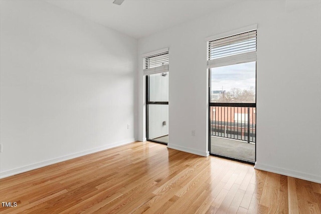 empty room featuring light wood-style flooring and baseboards