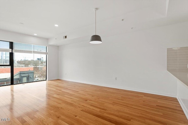 interior space featuring light wood-style floors, visible vents, baseboards, and recessed lighting