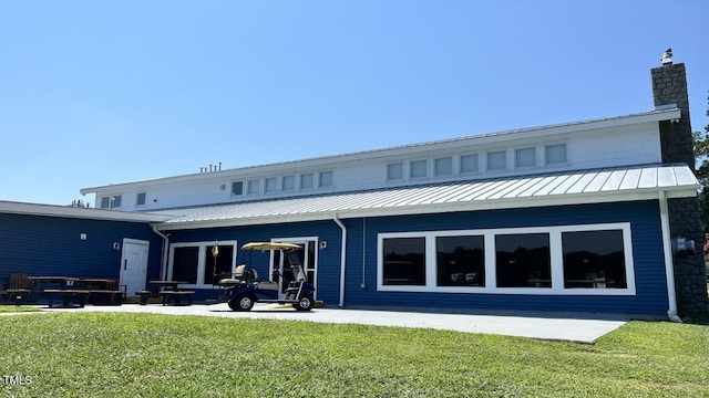 rear view of house with a patio area and a yard