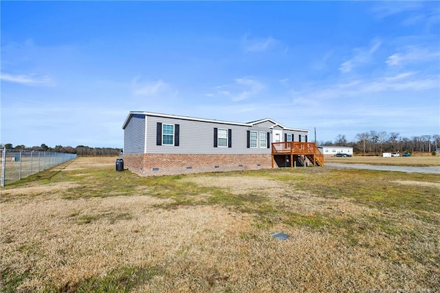 manufactured / mobile home with a deck and a front lawn