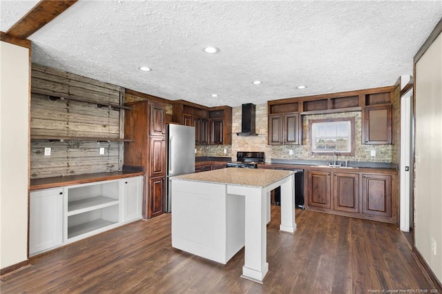 kitchen with black electric range, stainless steel refrigerator, dark hardwood / wood-style floors, a kitchen island, and wall chimney range hood