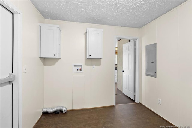 clothes washing area featuring a textured ceiling, electric panel, hookup for a washing machine, cabinets, and dark hardwood / wood-style flooring