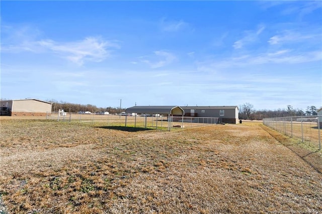 view of yard with a carport and a rural view