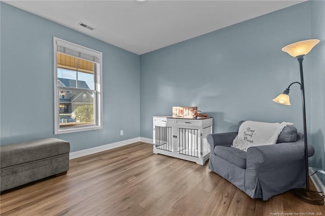 living area with hardwood / wood-style flooring