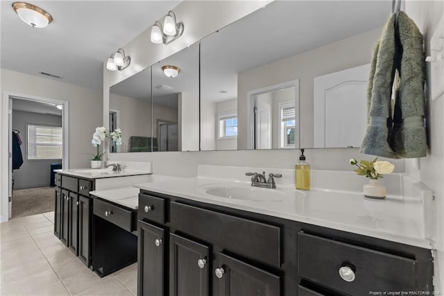 bathroom featuring walk in shower, tile patterned floors, and vanity