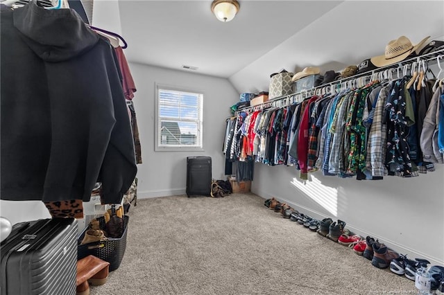 spacious closet featuring carpet and vaulted ceiling