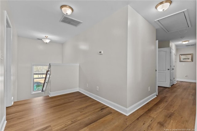 hallway with hardwood / wood-style flooring