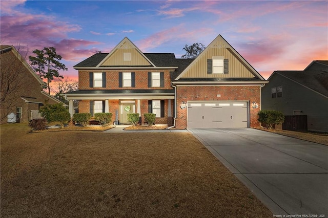 view of front facade featuring a garage, concrete driveway, a front lawn, and brick siding