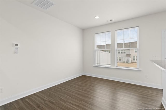 spare room featuring dark hardwood / wood-style floors