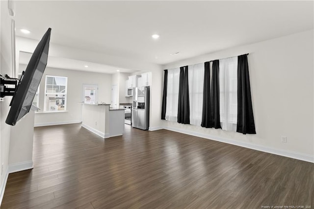 unfurnished living room featuring dark hardwood / wood-style flooring