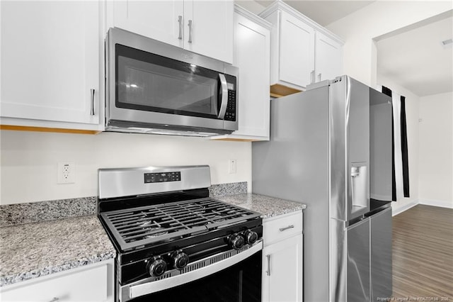 kitchen featuring white cabinets, stainless steel appliances, dark hardwood / wood-style flooring, and light stone countertops