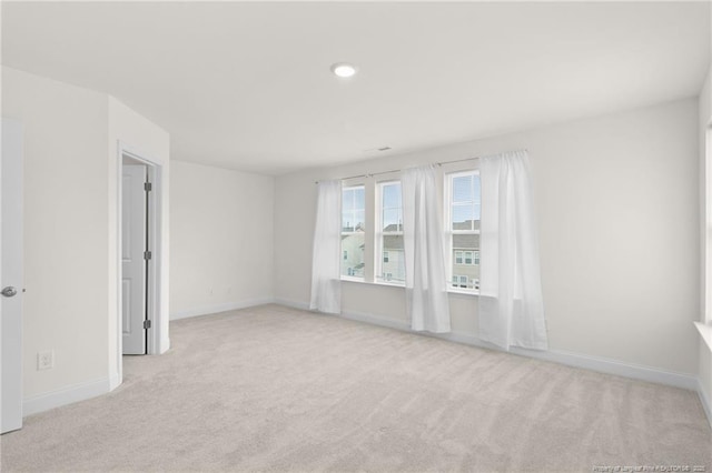 unfurnished room with light colored carpet