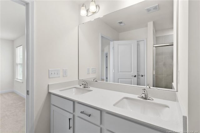 bathroom featuring walk in shower and vanity