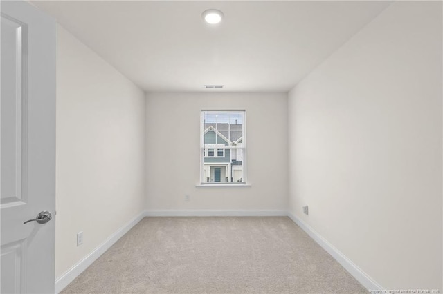 unfurnished room featuring light colored carpet