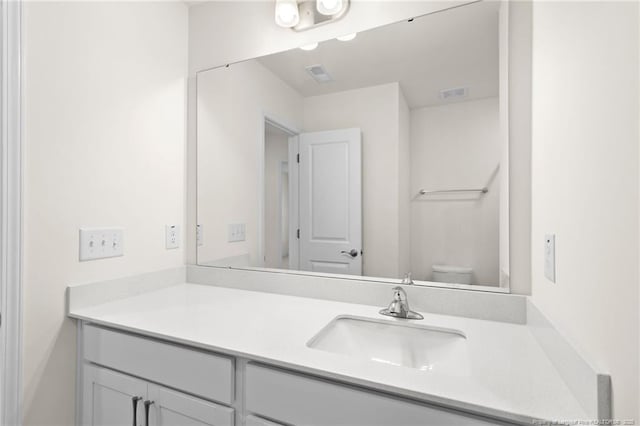 bathroom with toilet and vanity