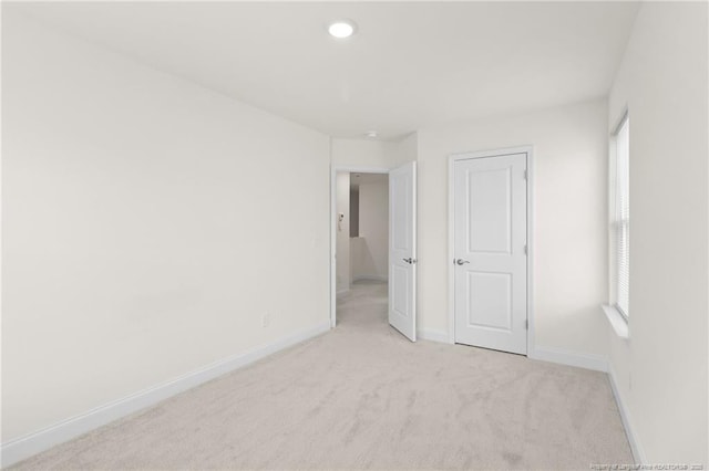 empty room featuring light colored carpet