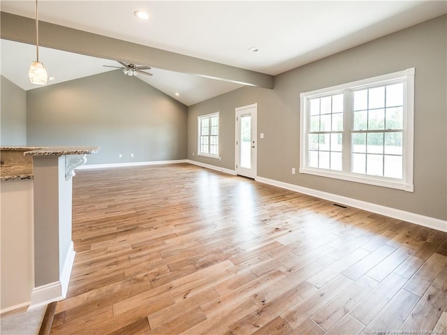 unfurnished living room with ceiling fan, light wood-type flooring, and vaulted ceiling