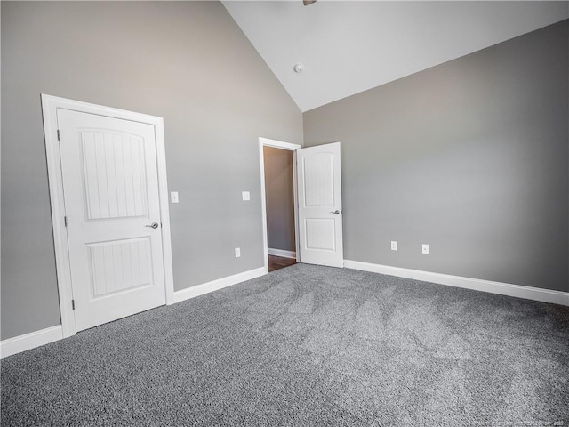 unfurnished bedroom featuring high vaulted ceiling and carpet flooring