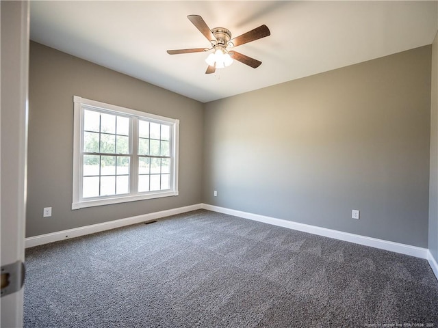 carpeted spare room with ceiling fan