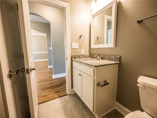 bathroom with tile patterned floors, vanity, and toilet