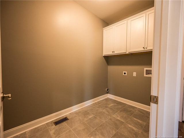 laundry room featuring electric dryer hookup, hookup for a washing machine, and cabinets