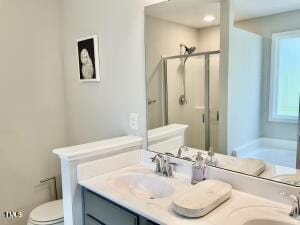 full bathroom with independent shower and bath, vanity, and toilet