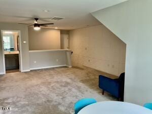 interior space featuring ceiling fan and carpet floors