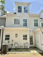 rear view of house featuring a patio and central AC