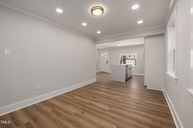 unfurnished living room featuring ornamental molding, dark wood-type flooring, and sink