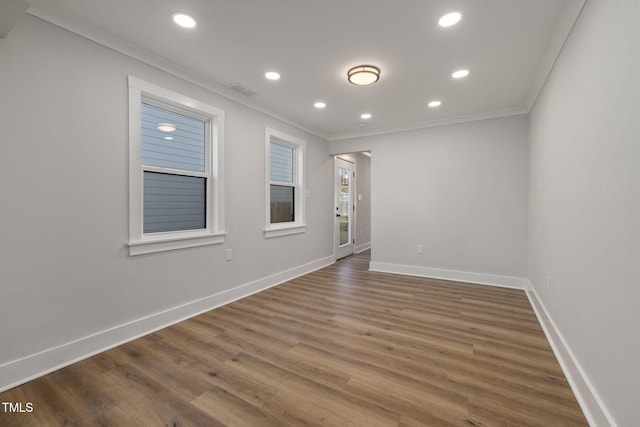 spare room with crown molding and dark hardwood / wood-style flooring