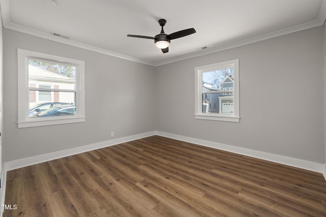 unfurnished room featuring ceiling fan, crown molding, and dark wood-type flooring