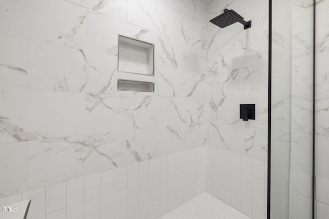 bathroom with a tile shower