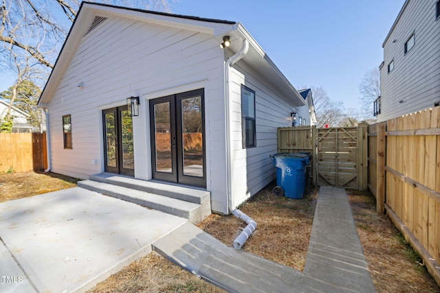 rear view of house with a patio area and french doors