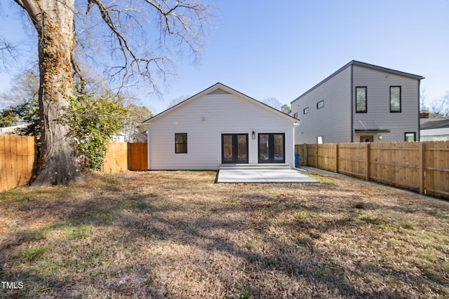 back of house featuring a patio and a yard