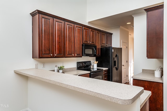 kitchen featuring black appliances, crown molding, and kitchen peninsula