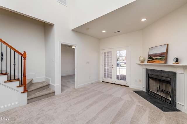 carpeted living room featuring french doors